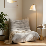Beige tufted floor chair in sophisticated nook