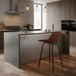 Brown leather bar stool with black metal legs in modern setting