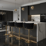 Four black and gold tufted bar stools in contemporary setting