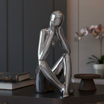 Silver thinking statue close-up in luxury setting