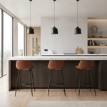 Three brown leather bar stools with black metal legs in modern setting