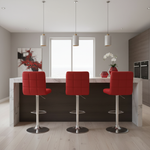 Three vibrant red bar stools with chrome frames in contemporary setting