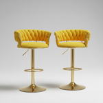 Two luxury bar stools with yellow seats and gold bases